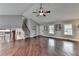Open-concept living room with hardwood floors, neutral walls, and a staircase at 417 Wood Branch St, Woodstock, GA 30188