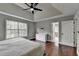 This main bedroom has wood floors, a tray ceiling, ceiling fan and an ensuite bathroom at 417 Wood Branch St, Woodstock, GA 30188
