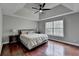 The main bedroom has wood floors, a tray ceiling, ceiling fan and a large window overlooking a private yard at 417 Wood Branch St, Woodstock, GA 30188