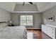 The main bedroom includes a bed, nightstands, a large window, and hardwood flooring at 417 Wood Branch St, Woodstock, GA 30188
