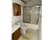 Compact bathroom with a shower-tub combo, commode, vanity, and medicine cabinet at 4401 Chestnut Lake Ave, Lithonia, GA 30038