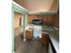 Cozy kitchen space with wood cabinetry, laminate countertops, and a microwave oven at 4401 Chestnut Lake Ave, Lithonia, GA 30038
