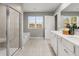 Bright bathroom features a double vanity, soaking tub, and separate glass-enclosed shower at 4958 Jatoba Rd, Acworth, GA 30101