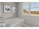 Bathroom featuring a relaxing soaking tub with a view from the large window at 4958 Jatoba Rd, Acworth, GA 30101