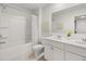 Bright, well-lit bathroom with double sinks, white cabinets, and a shower-tub combination for modern convenience at 4958 Jatoba Rd, Acworth, GA 30101