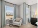 Bedroom boasts abundant natural light, chair with end table, stylish décor, and plush carpeting at 4958 Jatoba Rd, Acworth, GA 30101