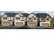 Charming townhome exteriors feature stone accents, neutral siding and attached garages at 4958 Jatoba Rd, Acworth, GA 30101