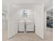Convenient laundry room featuring side-by-side washer and dryer, shelving, and plenty of room for storage at 4958 Jatoba Rd, Acworth, GA 30101