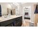 Bathroom with a double vanity and view to the primary bedroom at 7620 Stoneridge Dr, Atlanta, GA 30328