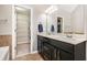 Bathroom featuring a double sink vanity and access to a walk-in closet at 7620 Stoneridge Dr, Atlanta, GA 30328