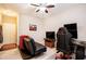 Cozy bedroom with a futon, an office setup, and a ceiling fan at 7620 Stoneridge Dr, Atlanta, GA 30328