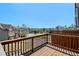 A wooden deck overlooks a neighborhood with neatly maintained homes and a lush tree line at 7620 Stoneridge Dr, Atlanta, GA 30328