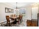 Inviting dining room with hardwood floors, elegant lighting, and a view of the front entrance, perfect for gatherings at 7620 Stoneridge Dr, Atlanta, GA 30328