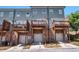 Exterior of townhomes featuring brick facades, balconies, and garage entrances at 7620 Stoneridge Dr, Atlanta, GA 30328