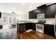 Well-appointed kitchen with dark cabinets, stainless steel appliances, and an open layout connecting to the living area at 7620 Stoneridge Dr, Atlanta, GA 30328
