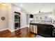 Open-concept kitchen with stainless steel appliances, granite countertops, and a convenient laundry area at 7620 Stoneridge Dr, Atlanta, GA 30328
