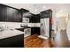 Stylish kitchen featuring dark cabinets, granite counters, and stainless steel appliances, combining functionality and elegance at 7620 Stoneridge Dr, Atlanta, GA 30328