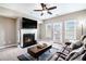 Bright living room with a fireplace, ceiling fan, and access to a balcony, providing natural light at 7620 Stoneridge Dr, Atlanta, GA 30328