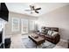 Comfortable living room with a fireplace, ceiling fan, and a large sofa, perfect for relaxation at 7620 Stoneridge Dr, Atlanta, GA 30328