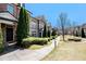 A row of brick townhomes with manicured landscaping and walkways at 7620 Stoneridge Dr, Atlanta, GA 30328