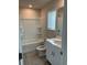 Bright bathroom with a shower-tub, white cabinets, and modern fixtures at 950 Sunny Lake Dr, Lawrenceville, GA 30043