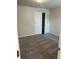 A carpeted room with white trim and door and a double closet at 950 Sunny Lake Dr, Lawrenceville, GA 30043
