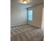 A carpeted bedroom with lots of light and a view into the bathroom at 950 Sunny Lake Dr, Lawrenceville, GA 30043