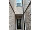 Charming entrance featuring a brick-lined walkway leading to a glass-paneled front door at 950 Sunny Lake Dr, Lawrenceville, GA 30043