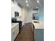 Modern kitchen with white cabinets, stainless steel appliances, and a kitchen island at 950 Sunny Lake Dr, Lawrenceville, GA 30043