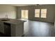 Open living area featuring wood floors, flowing seamlessly from the kitchen to sliding glass doors and bright windows at 950 Sunny Lake Dr, Lawrenceville, GA 30043