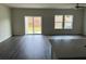 Bright open-concept living area with dark wood floors, flowing to sliding glass doors and bright windows at 950 Sunny Lake Dr, Lawrenceville, GA 30043