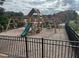 Community playground featuring a wooden playset with swings, slide, and climbing area at 950 Sunny Lake Dr, Lawrenceville, GA 30043