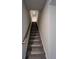 Staircase with carpet and wooden railing, offering easy access to the upper levels at 950 Sunny Lake Dr, Lawrenceville, GA 30043