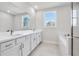 Bright bathroom with double vanity, white cabinets, quartz countertops, and a large mirror at 2540 Silver Star Ne Dr, Marietta, GA 30066