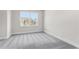 Bedroom with neutral carpet, white baseboards, and a large window that let in lots of light at 2540 Silver Star Ne Dr, Marietta, GA 30066