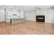 Open concept living room with gas fireplace and adjacent kitchen at 2540 Silver Star Ne Dr, Marietta, GA 30066