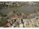 A high aerial view of neighborhood homes situated around a pristine lake at 2674 Hosanna Dr, Powder Springs, GA 30127
