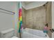 Tiled shower over tub with colorful curtains at 2674 Hosanna Dr, Powder Springs, GA 30127