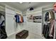 Walk-in closet with custom shelving, hanging racks, drawers, and padded bench at 2674 Hosanna Dr, Powder Springs, GA 30127