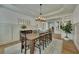 Bright dining room featuring a rustic wood table, elegant wainscoting and modern light fixture at 2674 Hosanna Dr, Powder Springs, GA 30127