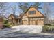 Stunning craftsman style home with a large driveway, 3-car garage, stone accents, and beautifully landscaped front yard at 2674 Hosanna Dr, Powder Springs, GA 30127