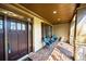 Inviting covered porch with brick flooring and comfortable seating, providing a relaxing outdoor space at 2674 Hosanna Dr, Powder Springs, GA 30127