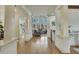 Spacious hallway with hardwood flooring and bright white trim and columns leading to living room and other areas at 2674 Hosanna Dr, Powder Springs, GA 30127