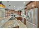 Gourmet kitchen features granite countertops, stainless steel appliances, and custom cabinetry at 2674 Hosanna Dr, Powder Springs, GA 30127