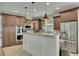Modern kitchen boasts stainless appliances, granite counters, custom cabinets, and stylish pendant lighting at 2674 Hosanna Dr, Powder Springs, GA 30127