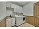 Laundry room with built-in cabinets, utility sink, washer and dryer at 2674 Hosanna Dr, Powder Springs, GA 30127
