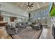 Open-concept living room with high ceilings, large windows, and a comfortable sectional sofa at 2674 Hosanna Dr, Powder Springs, GA 30127