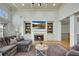 Inviting living room featuring a cozy fireplace, built-in shelving, and scenic outdoor views at 2674 Hosanna Dr, Powder Springs, GA 30127