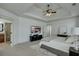 Well-lit main bedroom with tray ceilings, carpet, and ensuite bathroom at 2674 Hosanna Dr, Powder Springs, GA 30127