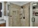 This tiled walk-in shower has a glass door, rainfall shower head and niche shelving at 2674 Hosanna Dr, Powder Springs, GA 30127